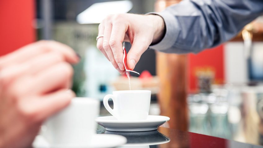 pouring sugar in coffee
