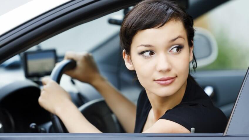 woman looking outside of the window while driving