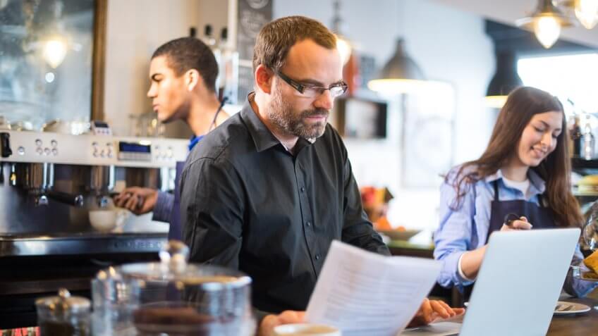 cafe owner reviewing documents cafe owner reviewing documents