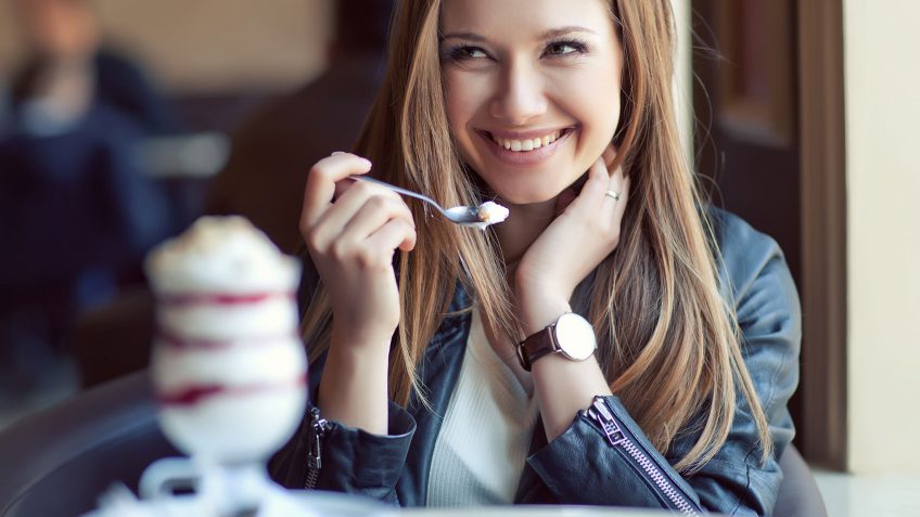 young woman eating a parfait