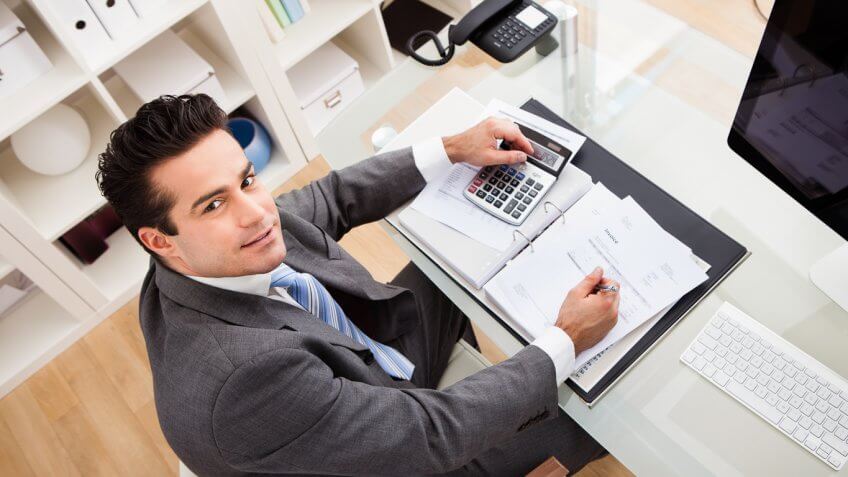 young business man at his desk posing for a picture young business man at his desk posing for a picture