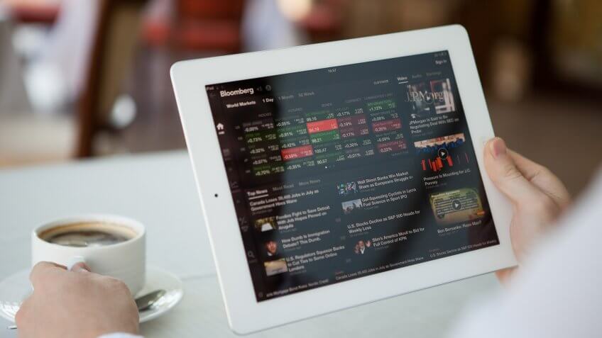 Man using Bloomberg app on iPad at lunch time