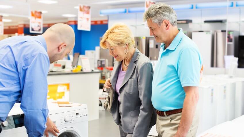 Senior couple buying a washing machine