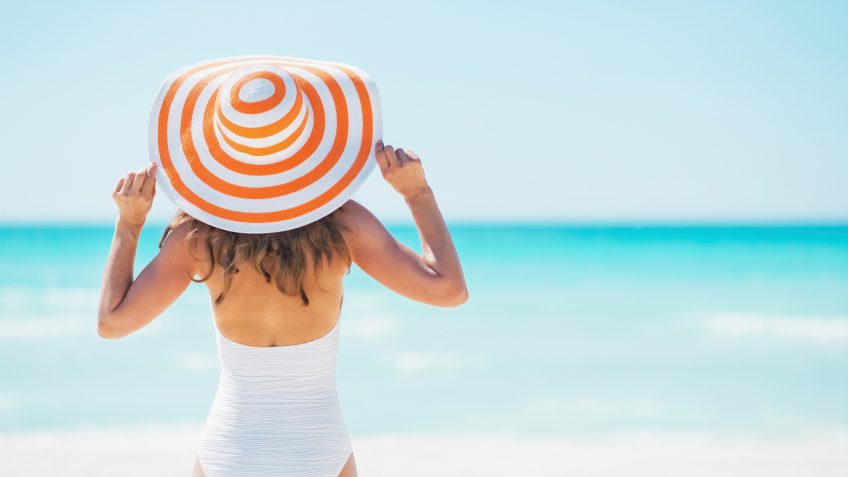 woman with a sun hat on the beach