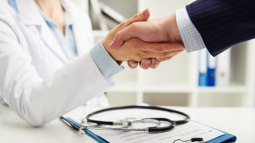 doctor shaking hands with patient doctor shaking hands with patient