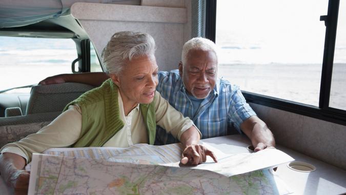 Retiring Too Early Senior couple reading map in RV