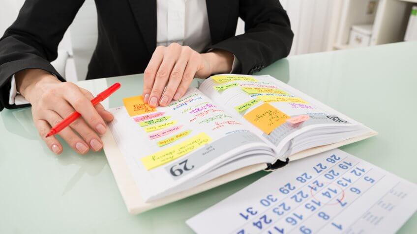 person reviewing his personal calendar person reviewing his personal calendar