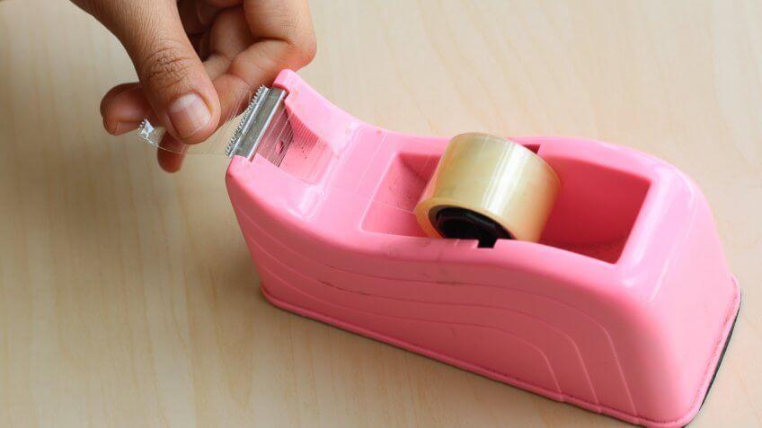 woman using tape dispenser