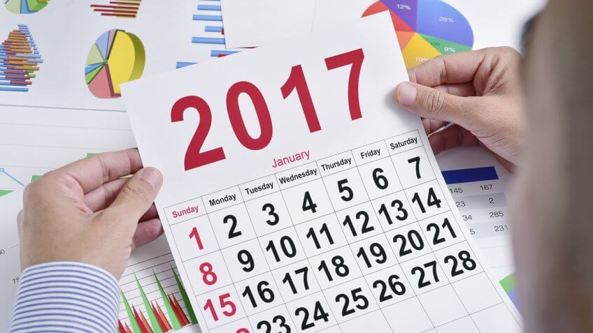 person looking at a 2017 calendar person looking at a 2017 calendar