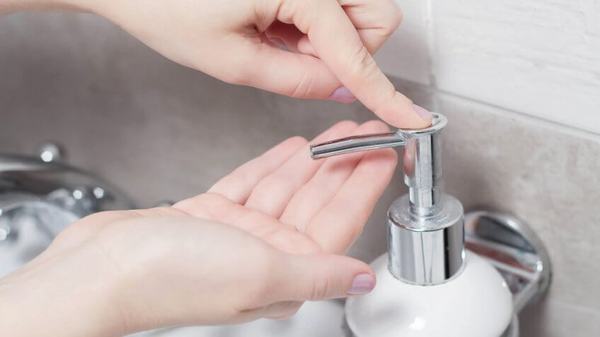 person using a soap dispenser