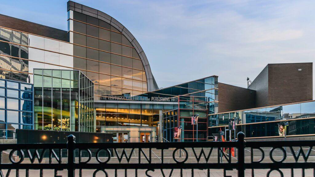 Louisville, Kentucky, USA - March 27th 2016: Kentucky Center for the Performing Arts building in Louisville Kentucky with rod iron fence which states 'Downtown Louisville' in foreground.