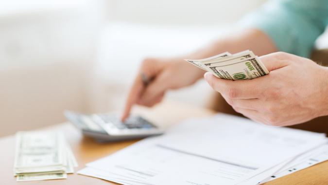 How to Save $1M man with calculator counting money and making notes at home
