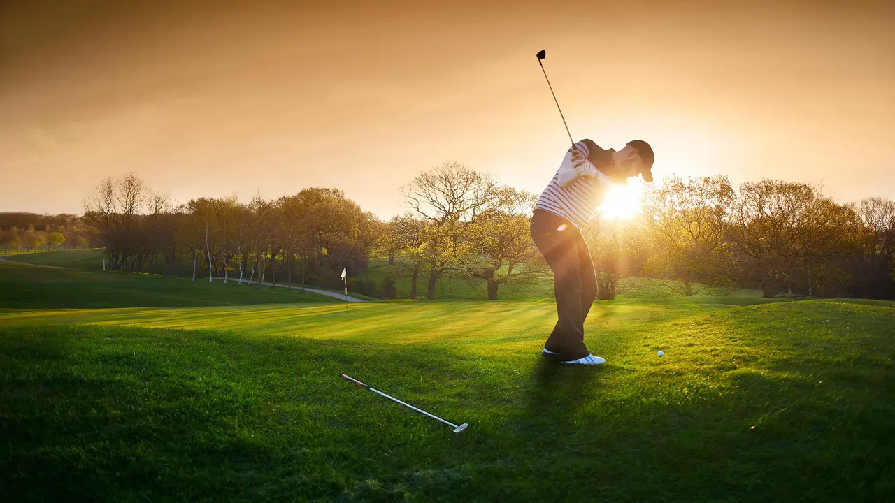 Backlit golf course with golfer chipping onto green - Stock imag, Putting Green, Shadow, Sunrise - Dawn, sunset