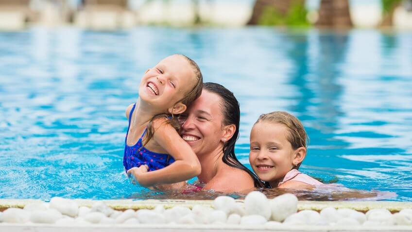 mom and two daughters in the swimming pool
