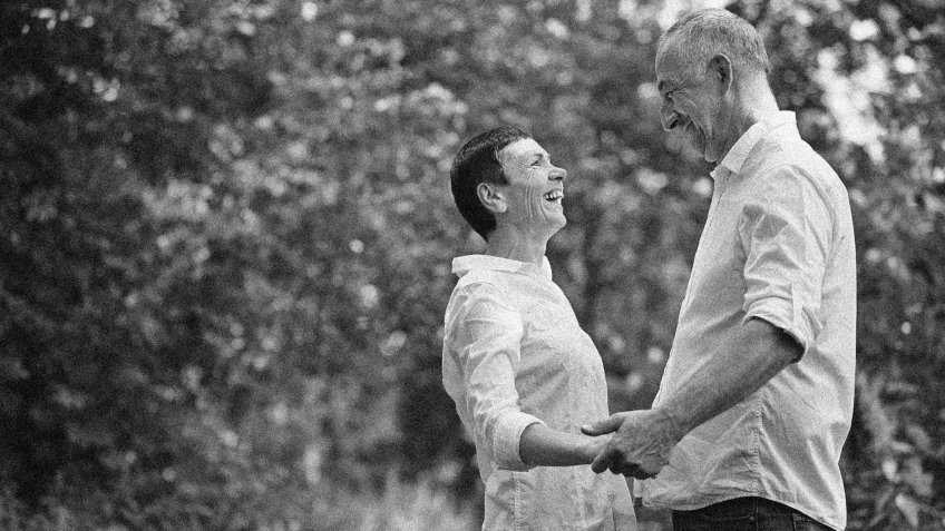 happy older couple holding hands together