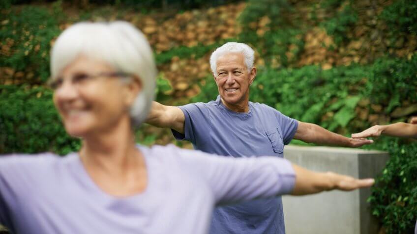 older couple doing yoga together