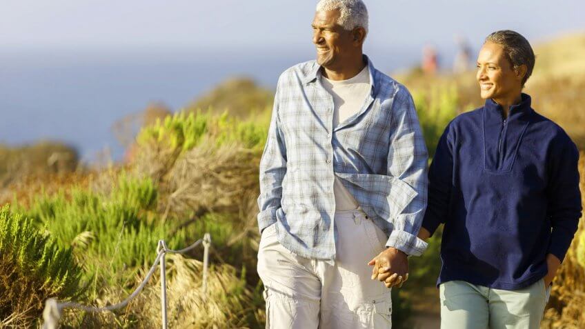older couple walking along the beach