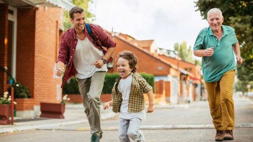 adults playing with a young child