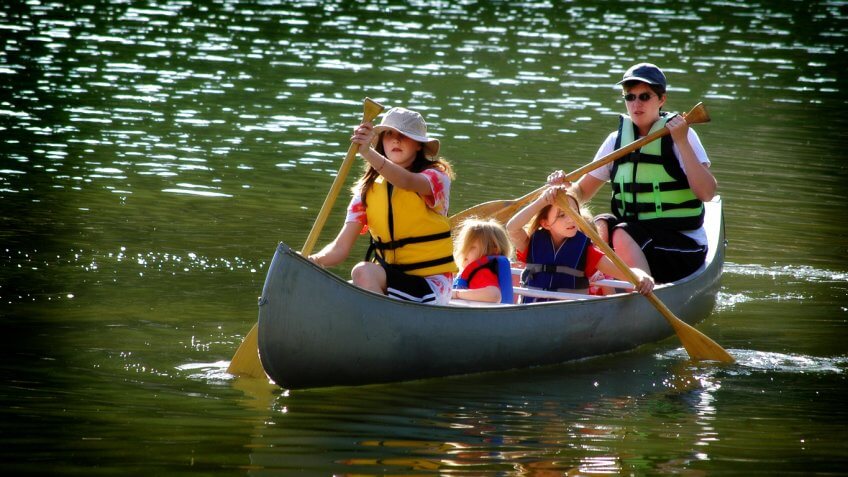 family canoeing on a lake