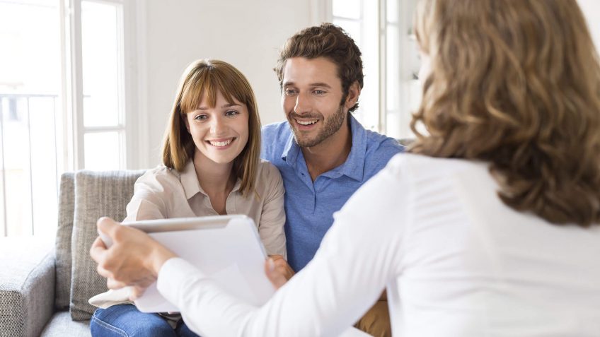 happy couple reading over a contract
