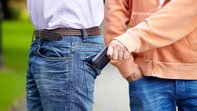 Pickpocket stealing wallet.