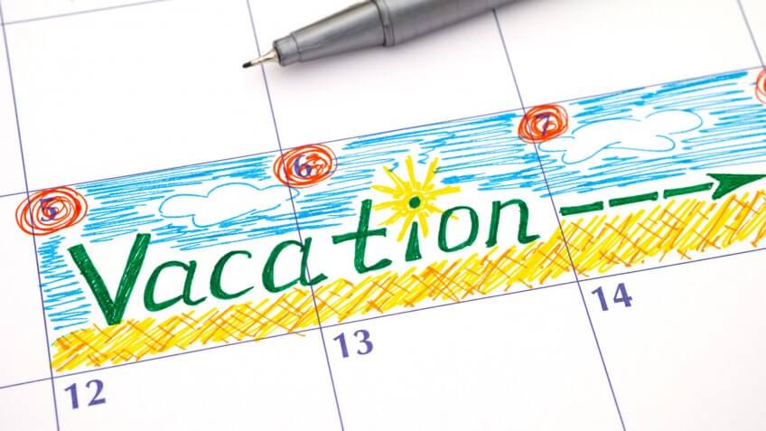 Reminder Vacation in calendar with pen.