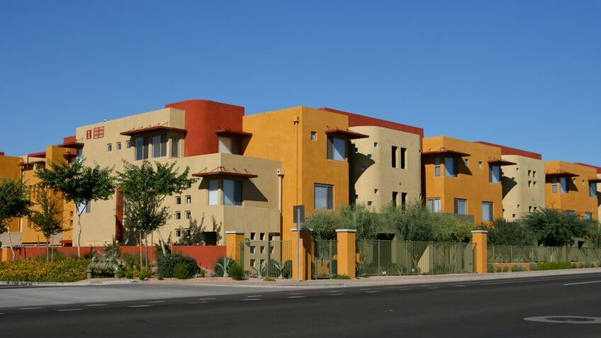 Street views of vibrantly colored luxury apartments in north Scottsdale, AZ with street for copy space (how convenient!).
