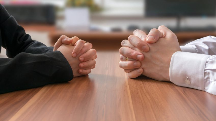 two people having a discussion at the dining table