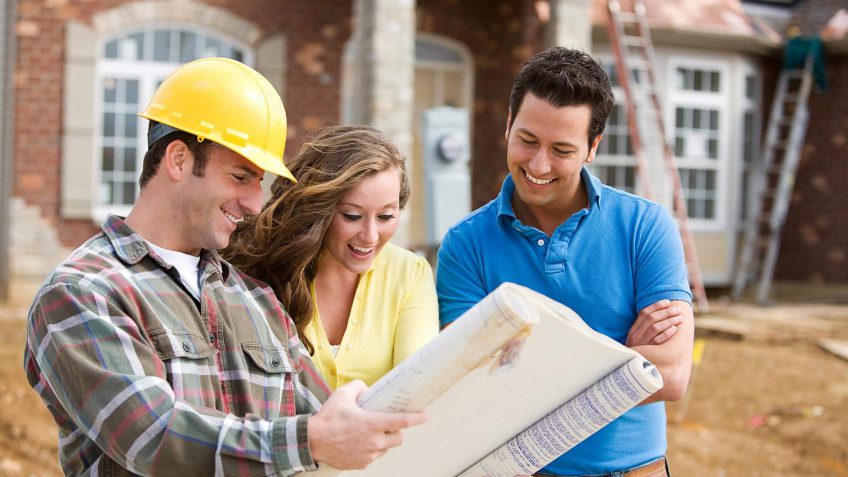 couple looking over the building plans to their new home.