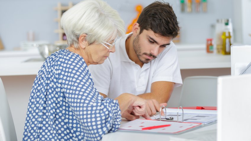 young-male-financial-senior-woman-money-bills young-male-financial-senior-woman-money-bills