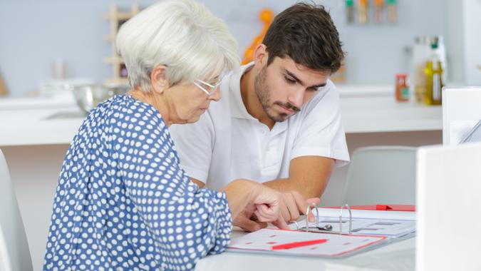 young-male-financial-senior-woman-money-bills