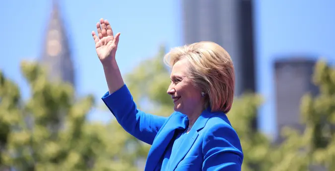 Hillary Clinton waving in blue suit