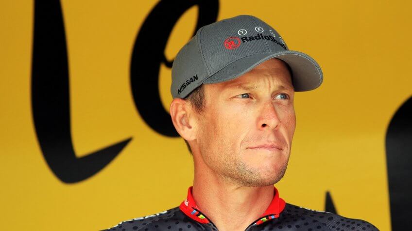RODEZ, FRANCE - JULY 17: Lance Armstrong of the USA and Team Radioshack signs on at the start of stage thirteen of the 2010 Tour de France from Rodez to Revel on July 17, 2010 in Revel, France.