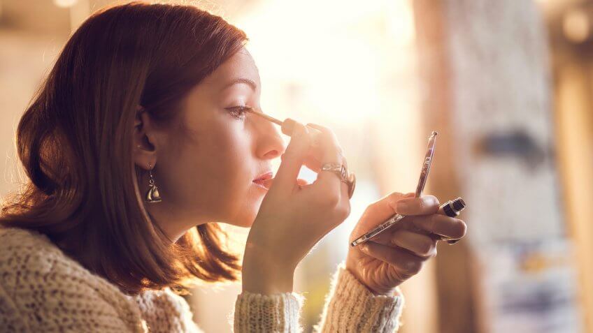 10 Items You Should Never Get at the Dollar Store, 2015, Adult, Adults Only, Applying, Beautiful People, Beauty, Beauty Product, Casual Clothing, Caucasian Ethnicity, Eye, Eyeliner, Females, Hand Mirror, Human Body Part, Human Eye, Lifestyles, Looking, Make-Up, Mirror, Modern, One Person, One Woman Only, One Young Woman Only, Only Women, Profile View, Young Adult, Young Women, holding, horizontal, indoors, leisure activity, lens flare, people, photography, preparation, side view, women