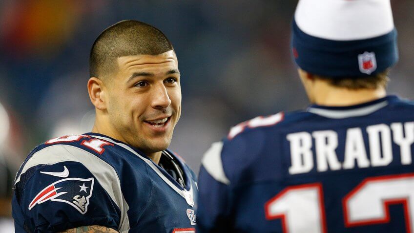 FOXBORO, MA - DECEMBER 10: Tom Brady #12 of the New England Patriots chats with Aaron Hernandez #81 against the Houston Texans at Gillette Stadium on December 10, 2012 in Foxboro, Massachusetts.