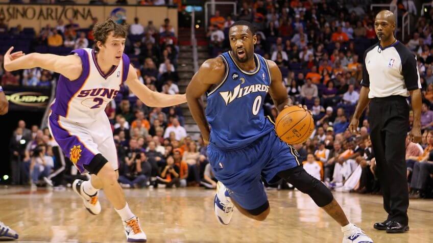 PHOENIX - DECEMBER 19: Gilbert Arenas #0 of the Washington Wizards drives the ball past Goran Dragic #2 of the Phoenix Suns during the NBA game at US Airways Center on December 19, 2009 in Phoenix, Arizona.