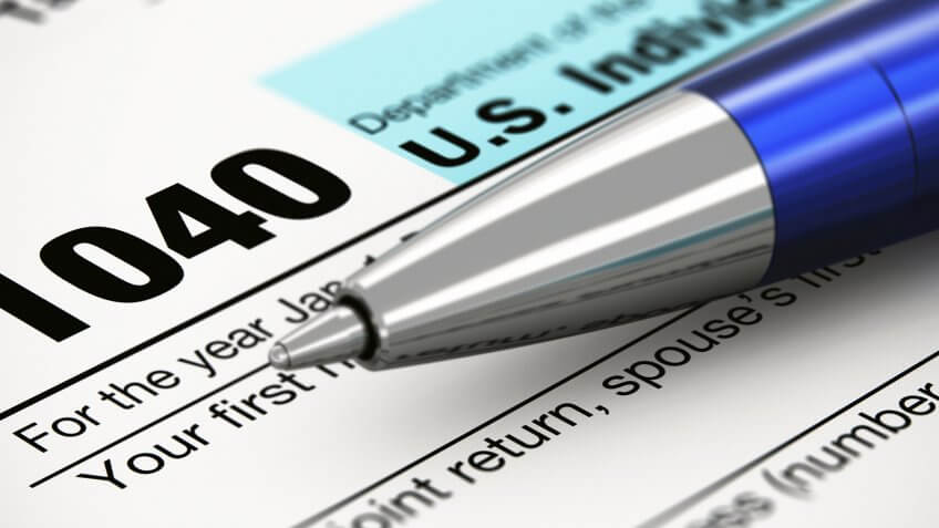 Cut taxes for the middle class. 1040 form with pen
