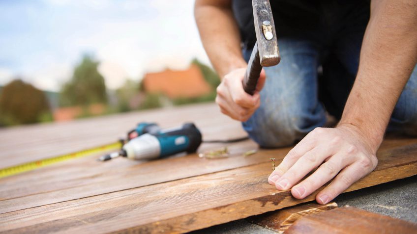 man building a deck