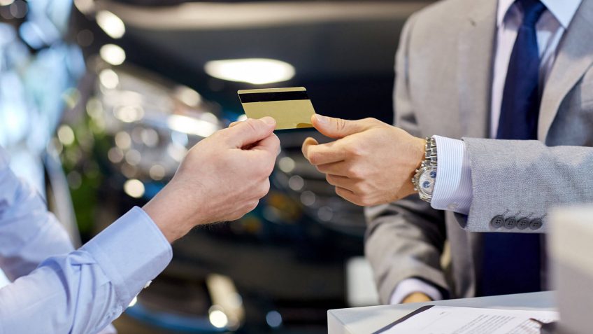 man paying with a gold credit card