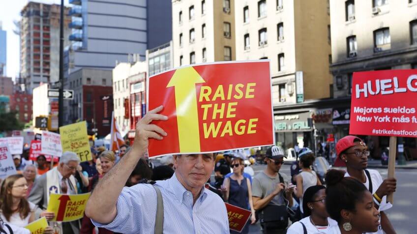 Trump says he wants states to determine the minimum wage. people protesting for higher wages