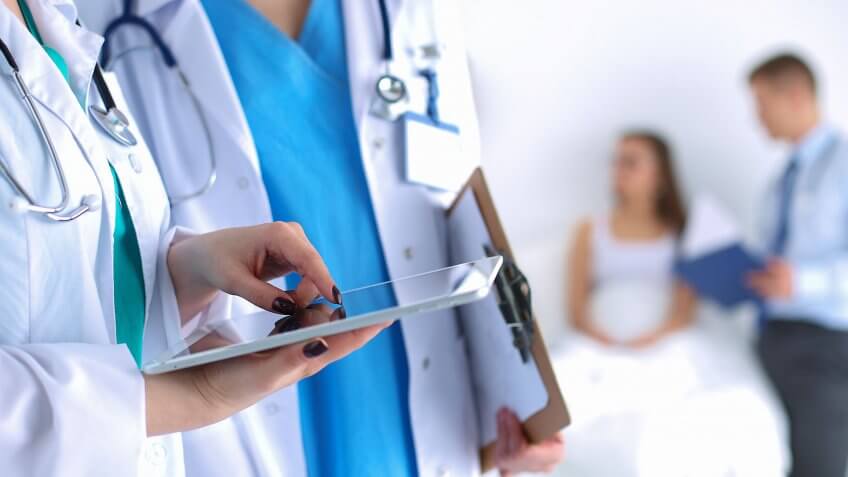 Trump wants to repeal Obamacare. doctors looking at ipad