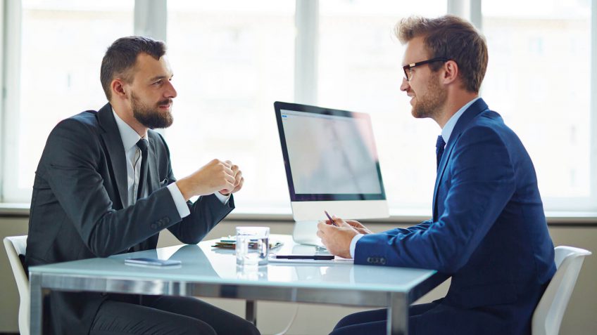 young man speaking to a banker about financing