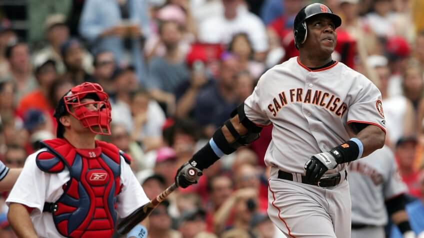 BOSTON - JUNE 17: Barry Bonds #25 of the San Francisco Giants hits a solo home run in the sixth inning as Doug Mirabelli #28 of the Boston Red Sox looks on, on June 17, 2007 at Fenway Park in Boston, Massachusetts.