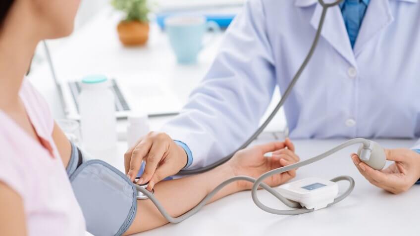 Expand the affordable care act. woman getting blood pressure checked