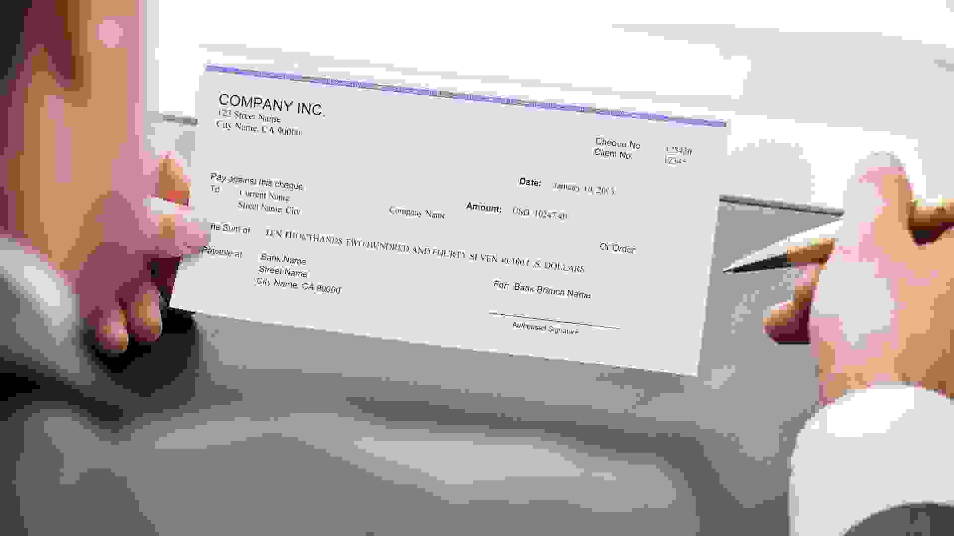 person about to sign a check