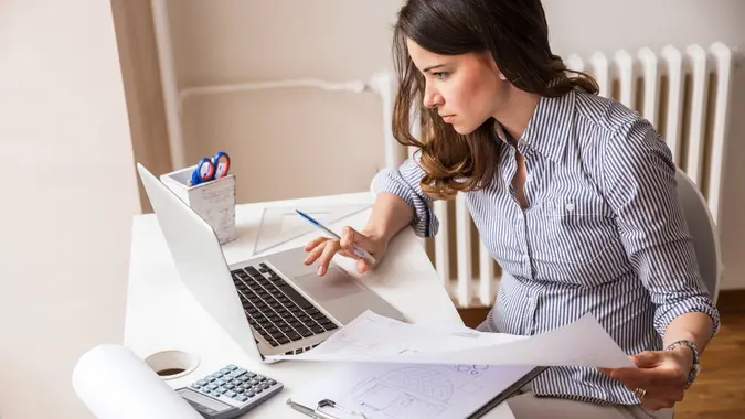 Young woman using laptop working and on her finances.