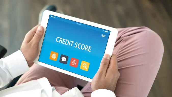 11807, 28 Things That Can Mess Up Your Credit Score, Horizontal, credit score, mobile, person, tablet
