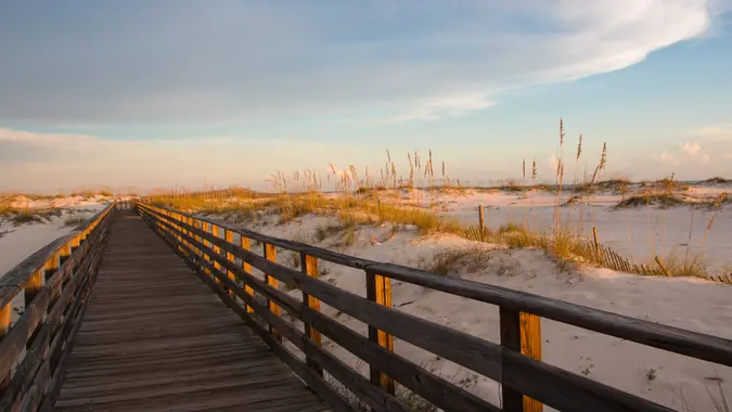 Alabama gulf shores boardwalk to beach at sunset