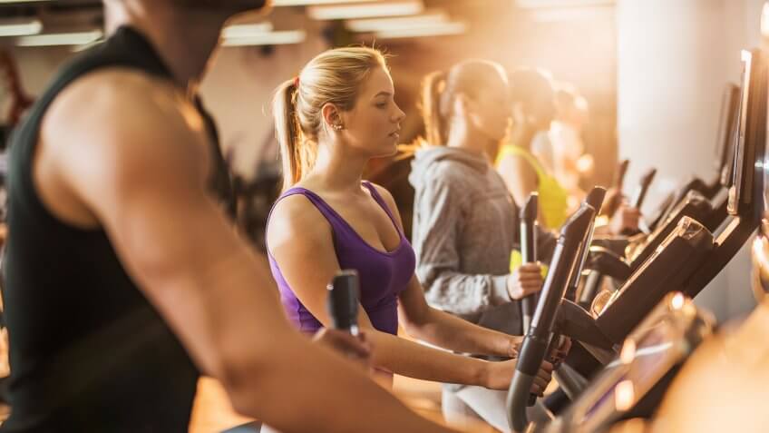Group of young people exercising in a health club.