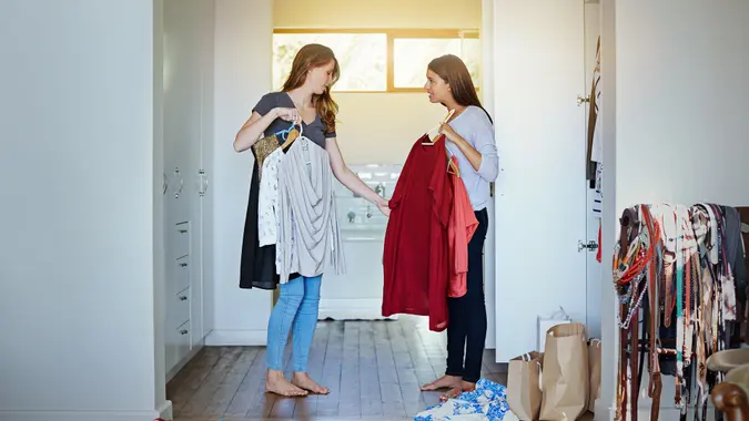 Shot of a young woman helping her friend choose something to wear.